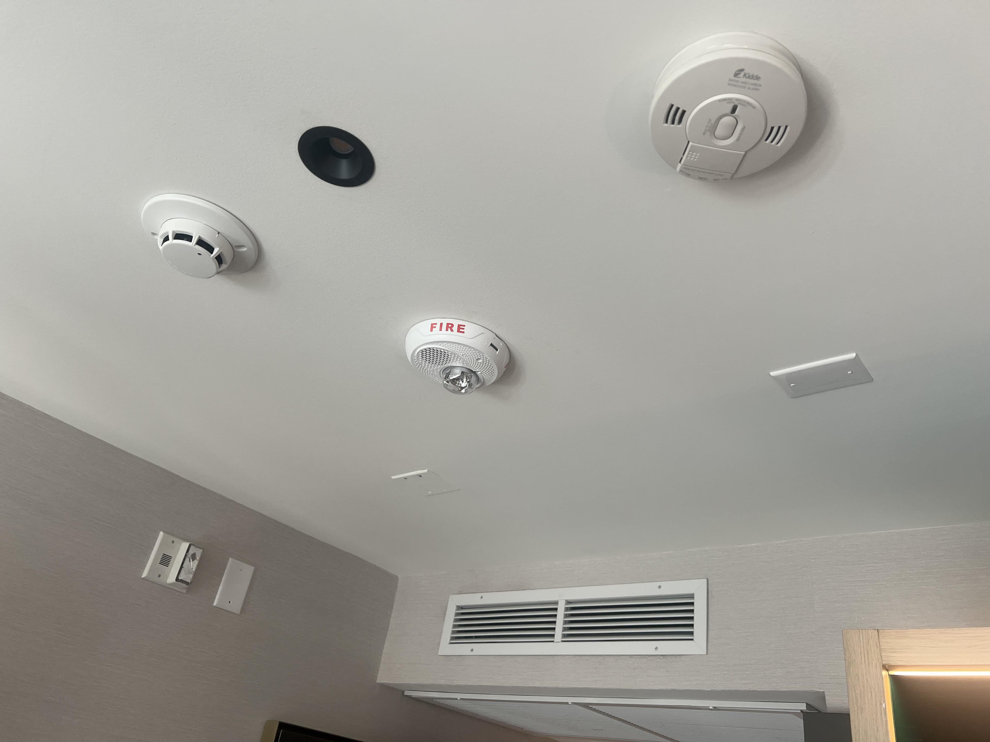 Fire Alarm System: Smoke detectors and alarms with panel selection matched to building size, zone mapping for actual floor layout, and access control integration for automatic evacuation